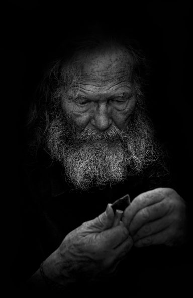 Man Making a flint arrowhead