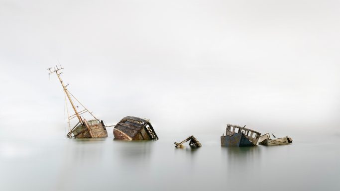 Were the old boats go to die. A series of small rocks with varying shapes and textures against a soft background.