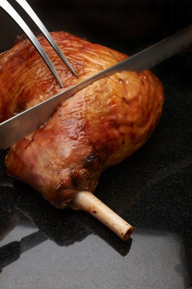 Cutting a roast leg of Lamb
